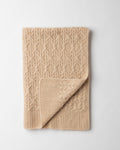 folded beige cashmere cable knit baby blanket.