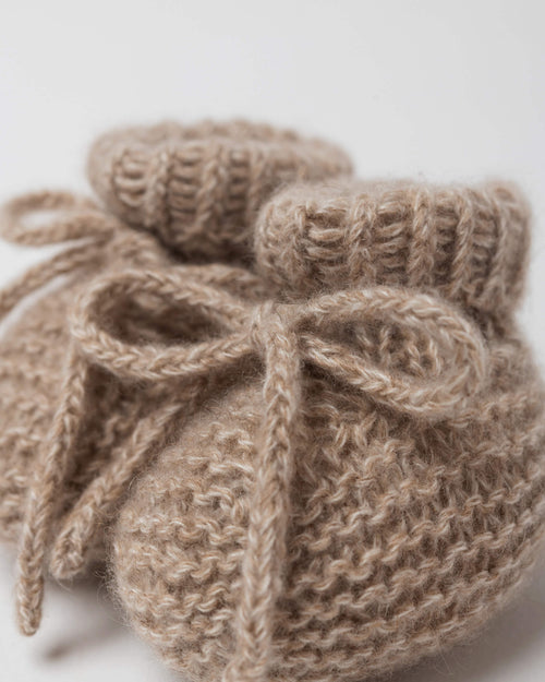 close up of knitted cashmere newborn booties in garter stitch
