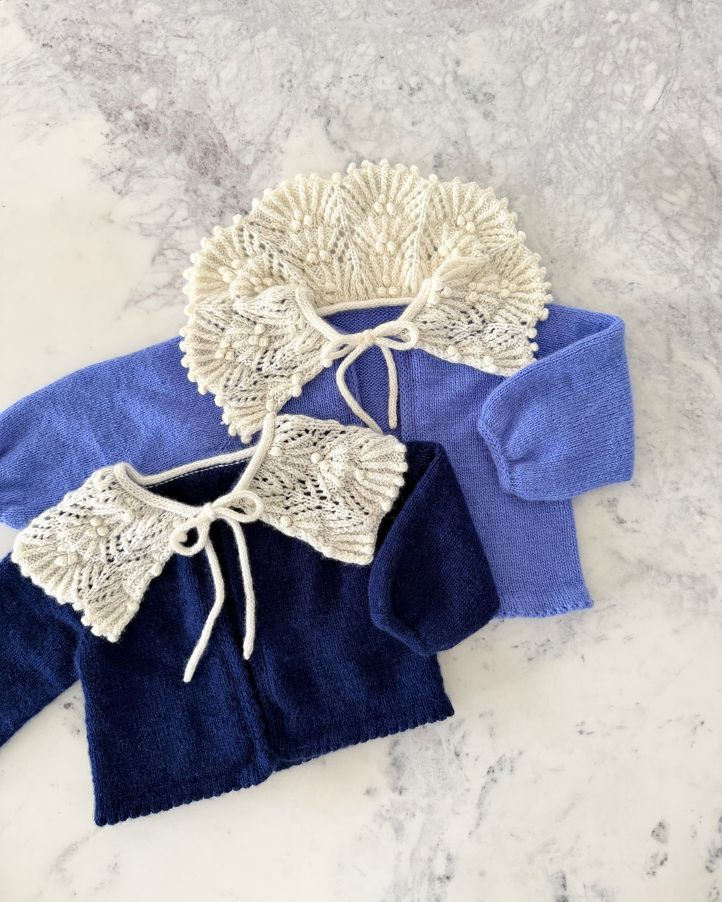 blue and navy cashmere baby cardigans with lace collars