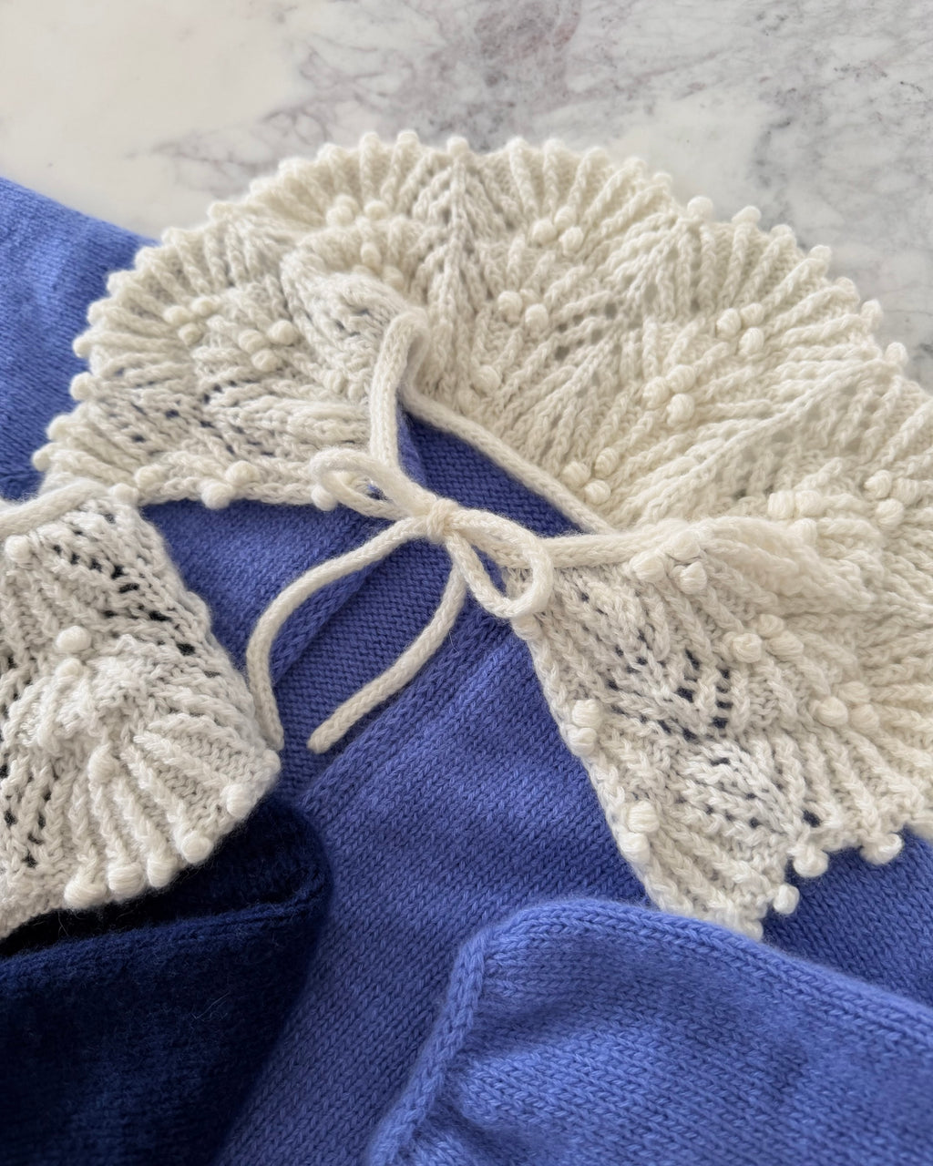 close up of cashmere lace collar on baby cardigan