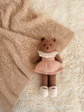 luxury baby girl cashmere teddy bear gift in pink dress lying on cashmere blanket