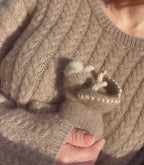 video of lady holding cashmere triceratops newborn cuddly toy